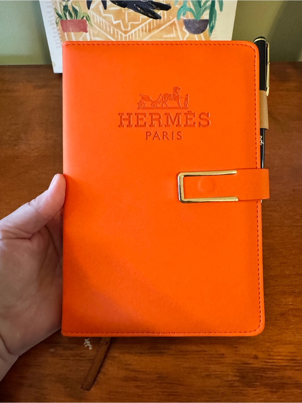 Hermès Daily Planner Journal With pen and paper.